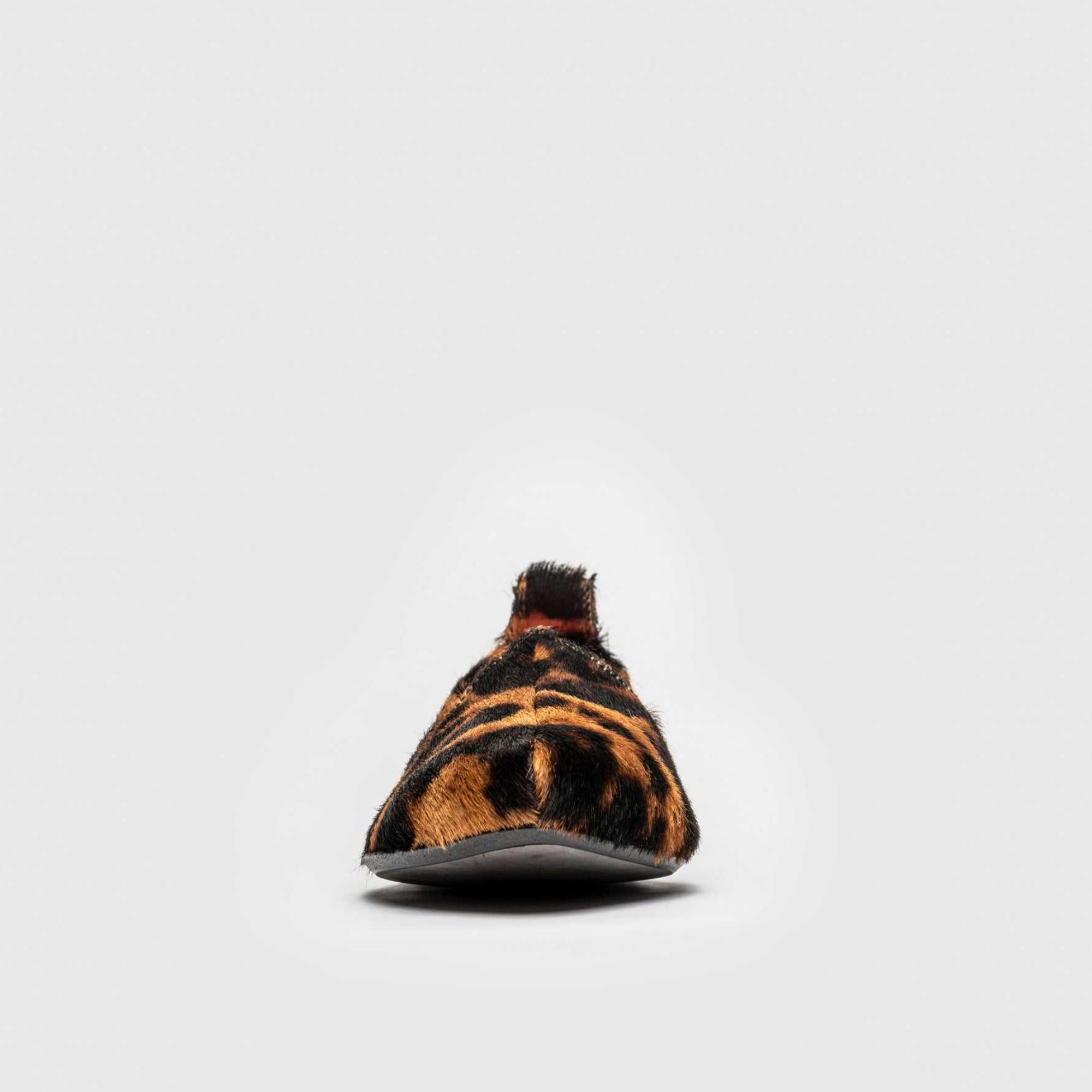 Single leopard print mojri slipper on a white background
