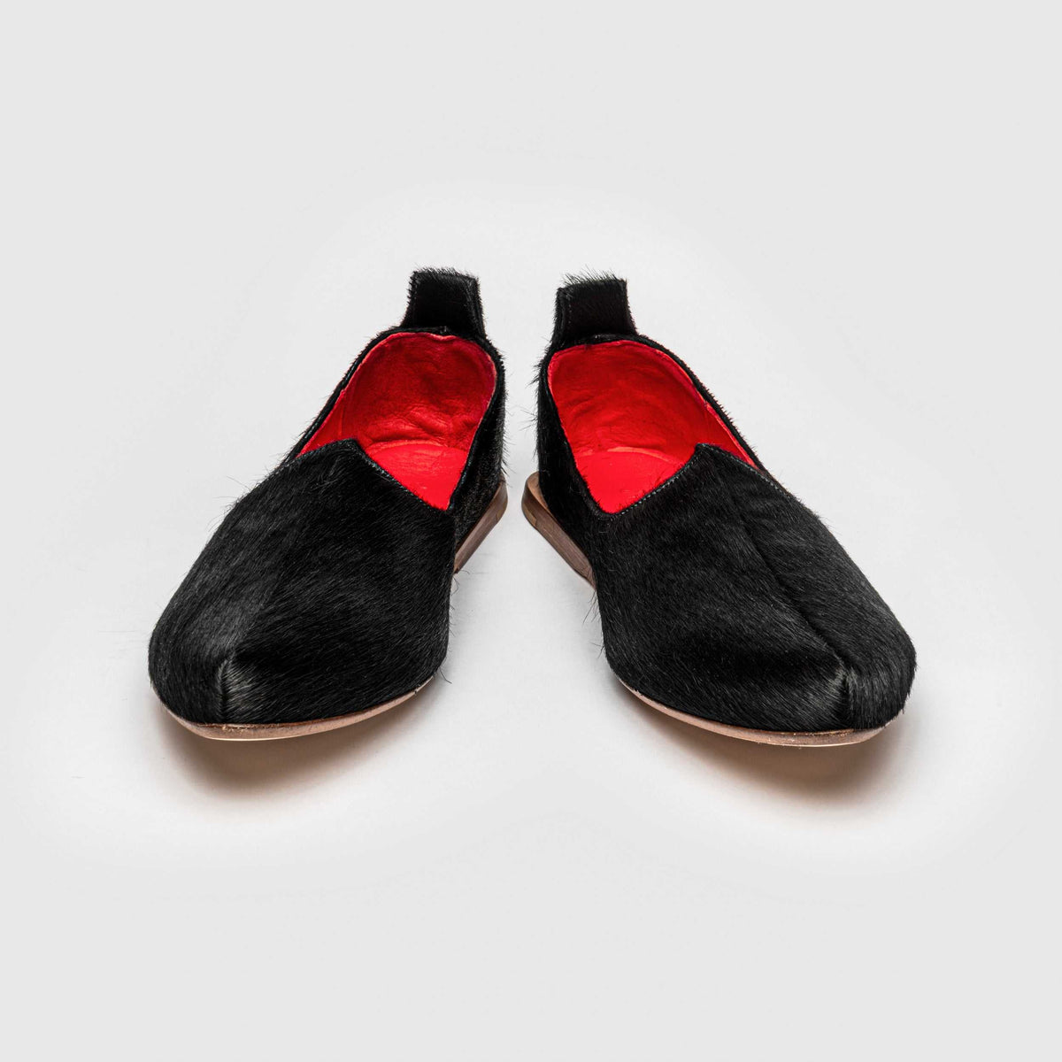 Pair of JOCO Austin Mojri (jutti) loafers in black pony hair calfskin with red lambskin lining, handmade in Italy