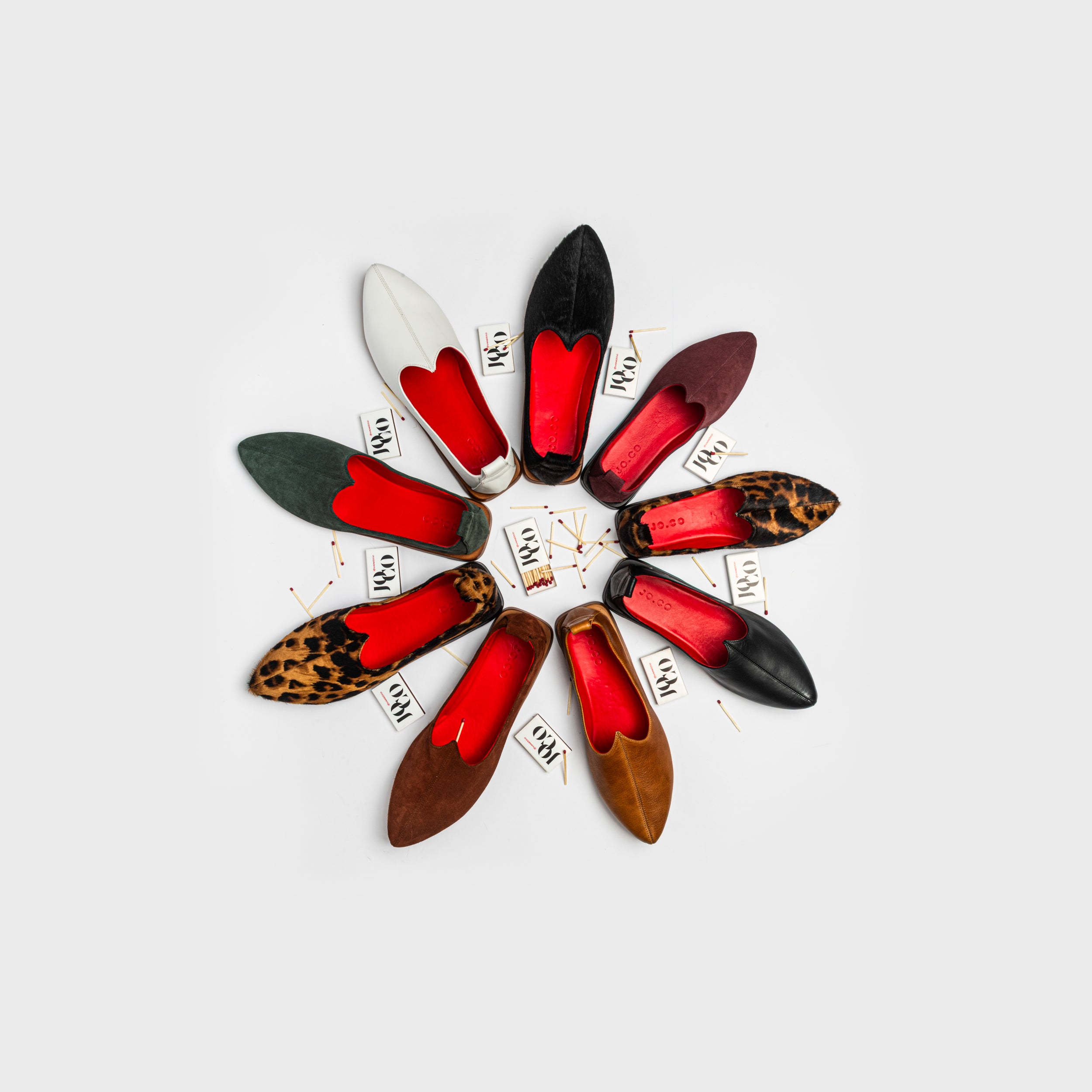 Colorful pointed-toe mojri loafers handmade in italy shoes arranged in a circular pattern on a light gray background showing all the JOCO collection